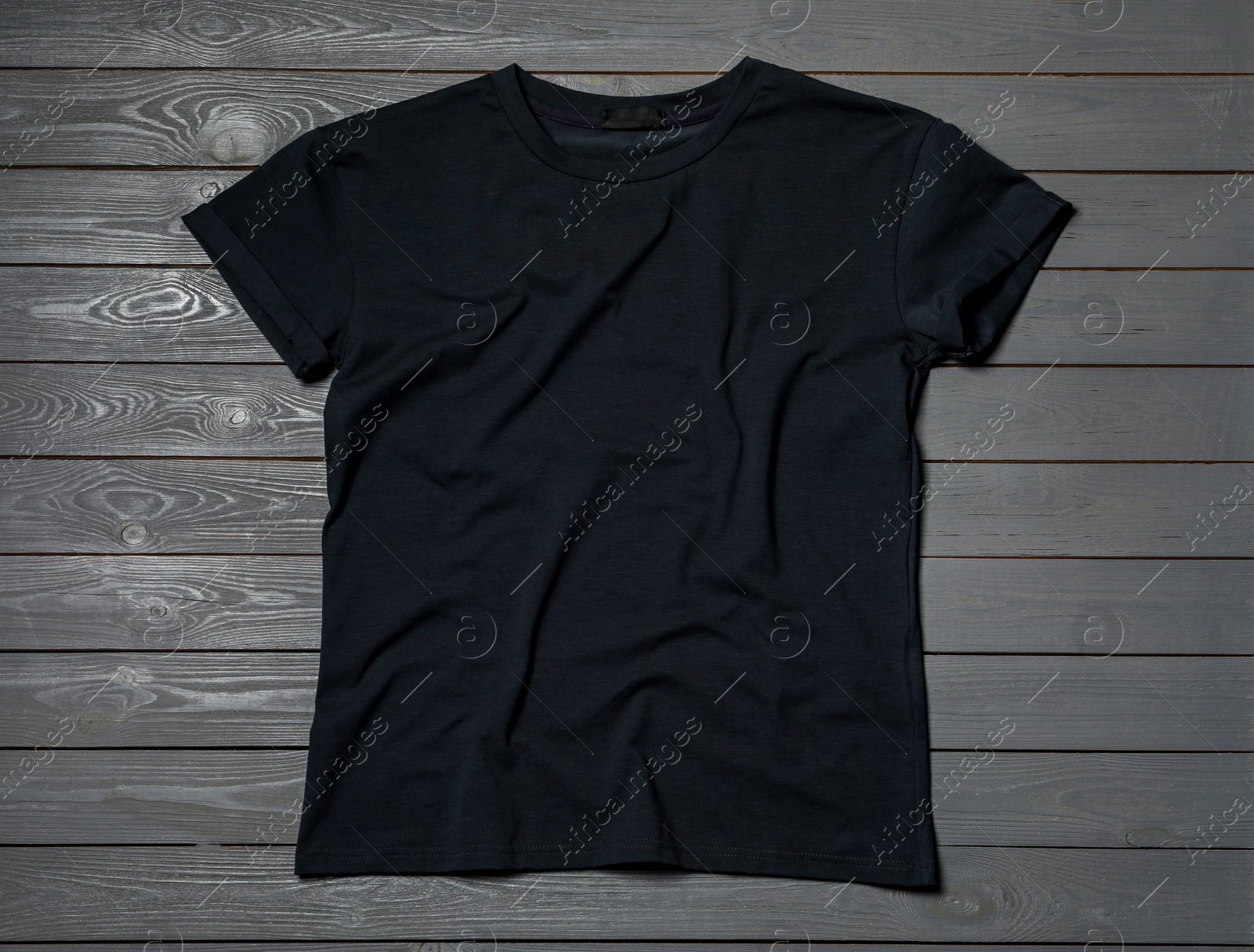 Photo of Stylish black T-shirt on gray wooden table, top view