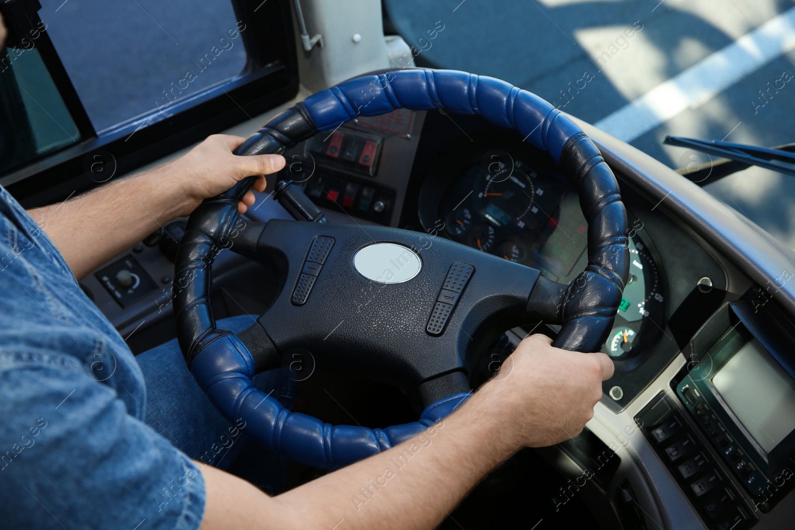 Photo of Professional bus driver at steering wheel. Passenger transportation