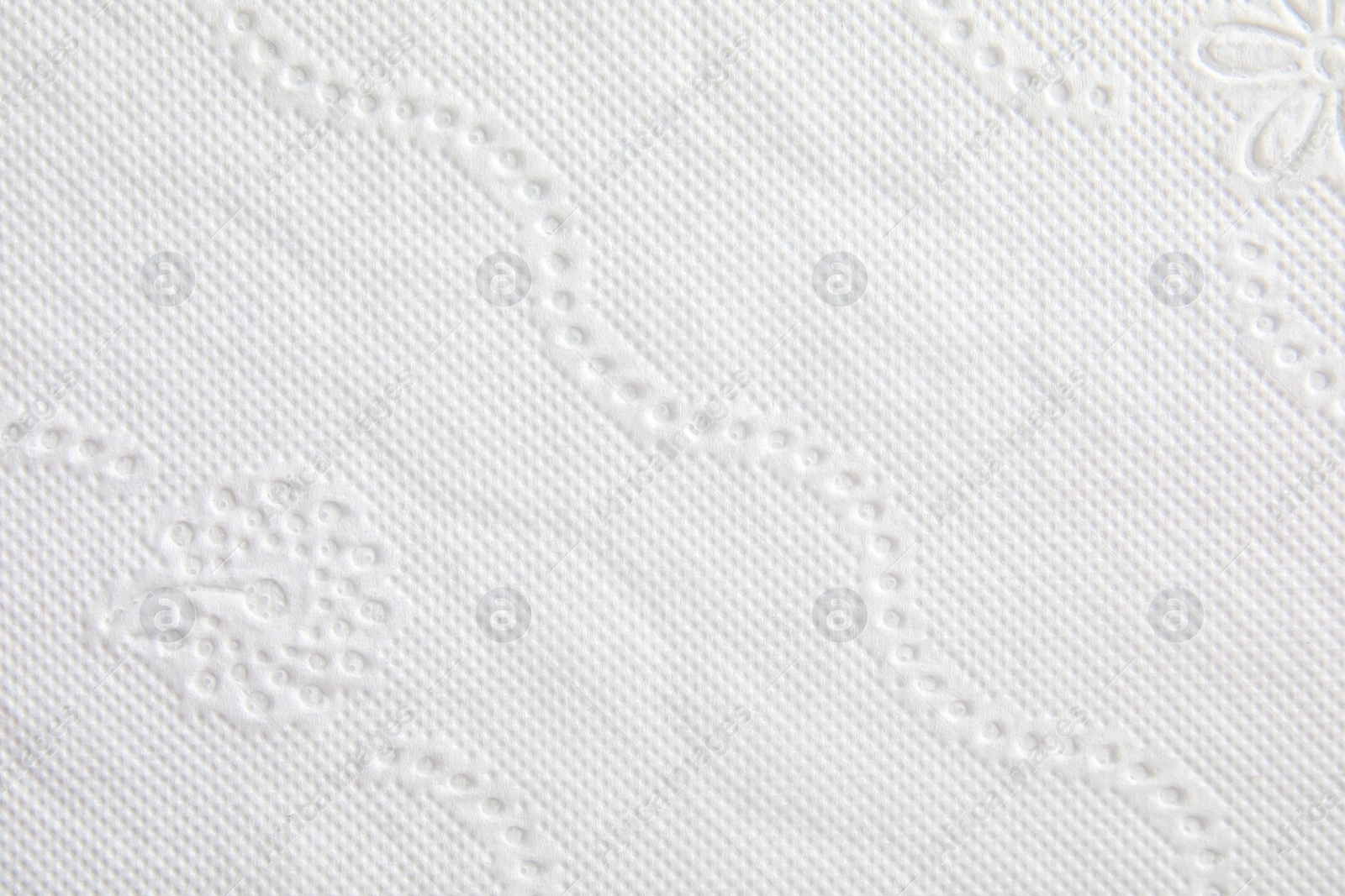 Photo of Toilet paper with pattern as background, closeup