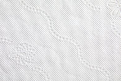 Photo of Toilet paper with pattern as background, closeup