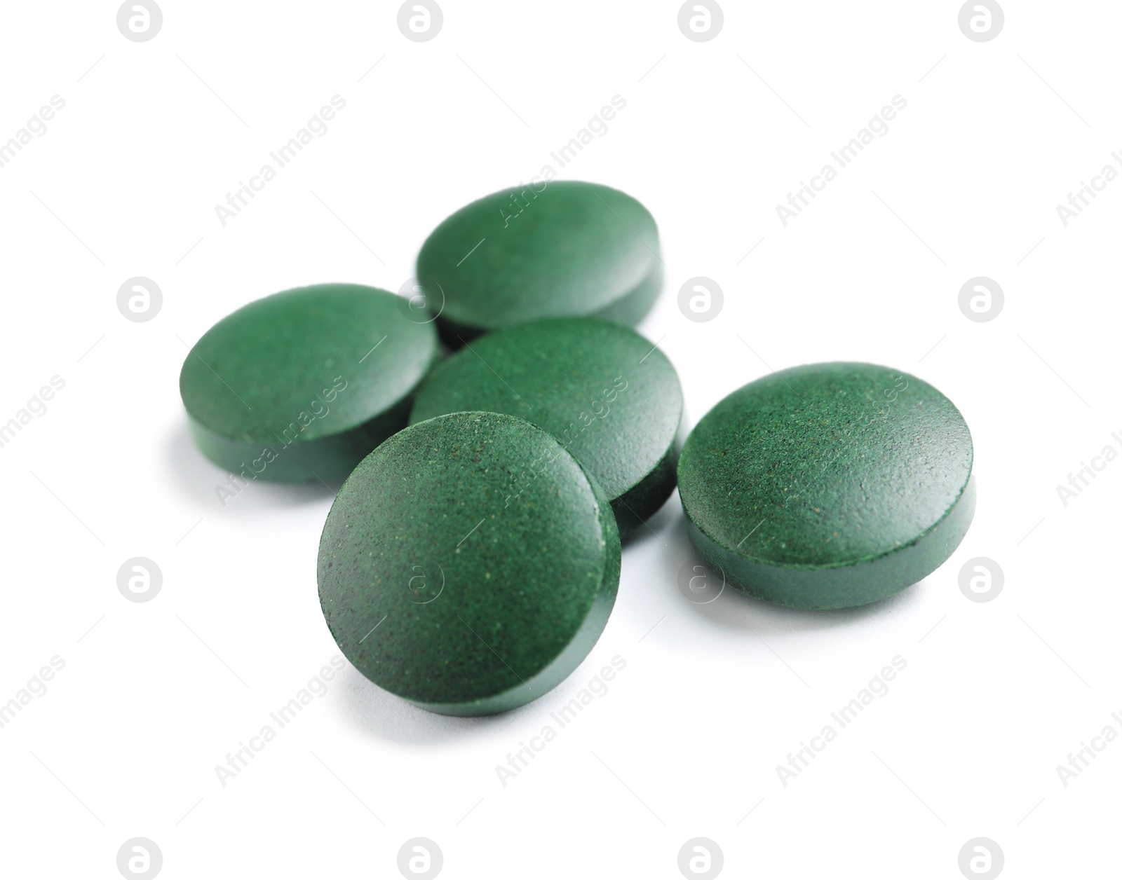 Photo of Spirulina tablets on white background. Healthy lifestyle