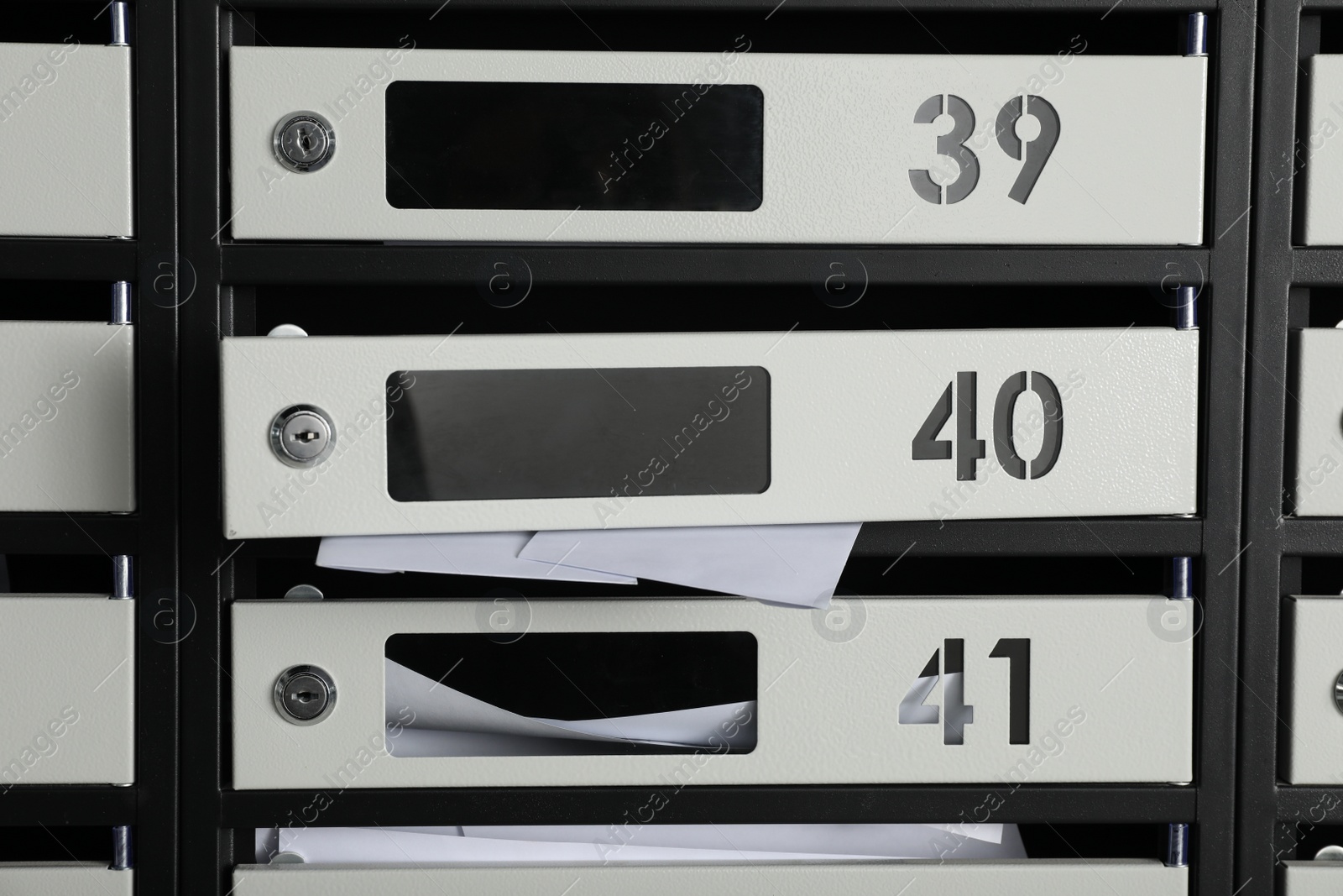 Photo of New mailboxes with keyholes, numbers and receipts