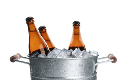 Photo of Metal bucket with bottles of beer and ice cubes isolated on white