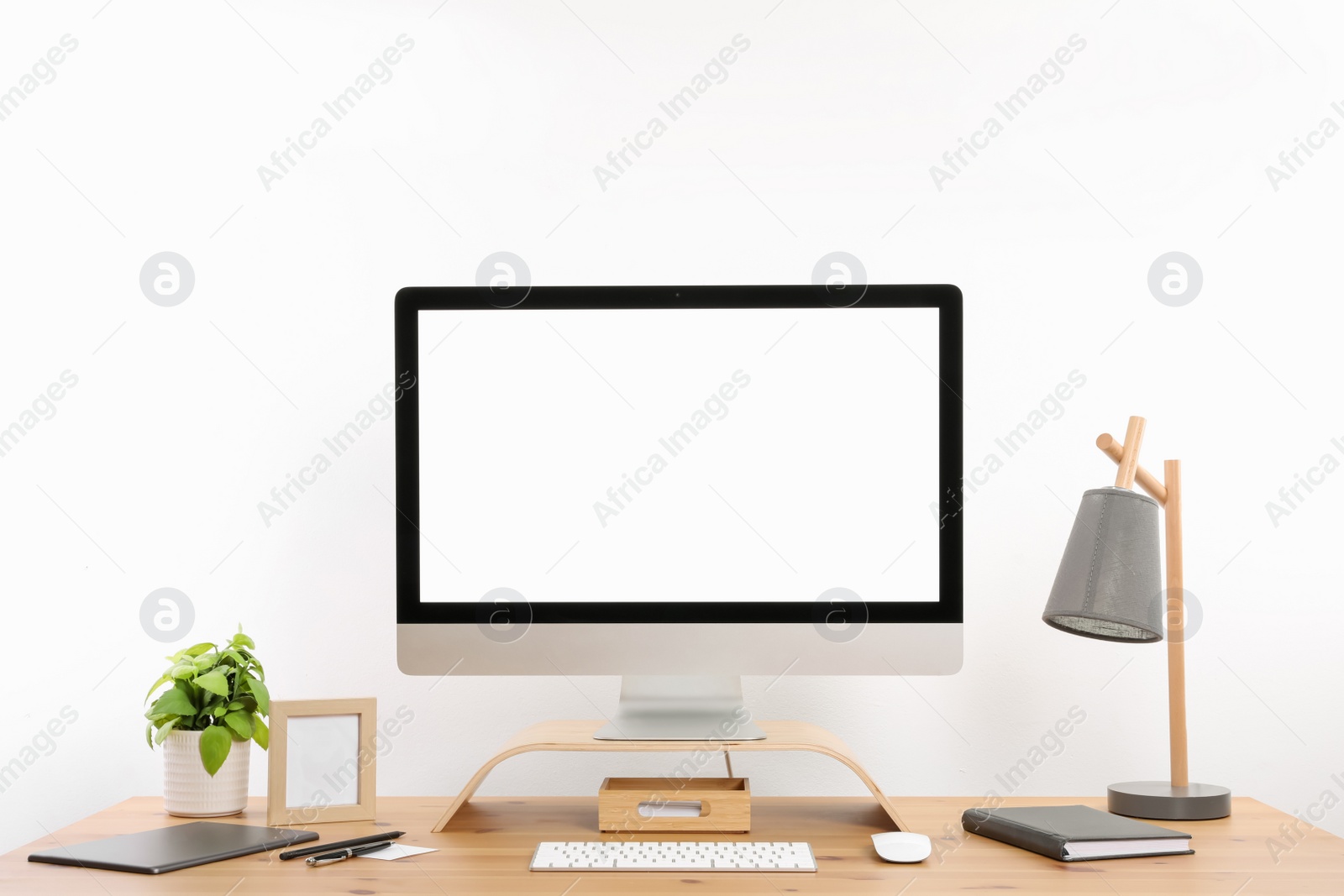 Photo of Modern computer with blank screen on desk, space for design. Comfortable workplace