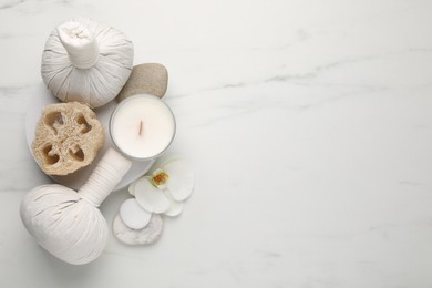 Flat lay composition with different spa products on white marble table. Space for text