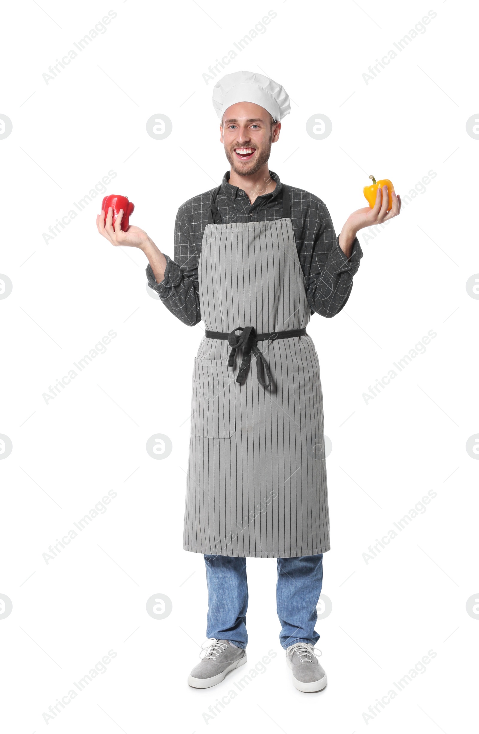 Photo of Professional chef holding peppers on white background