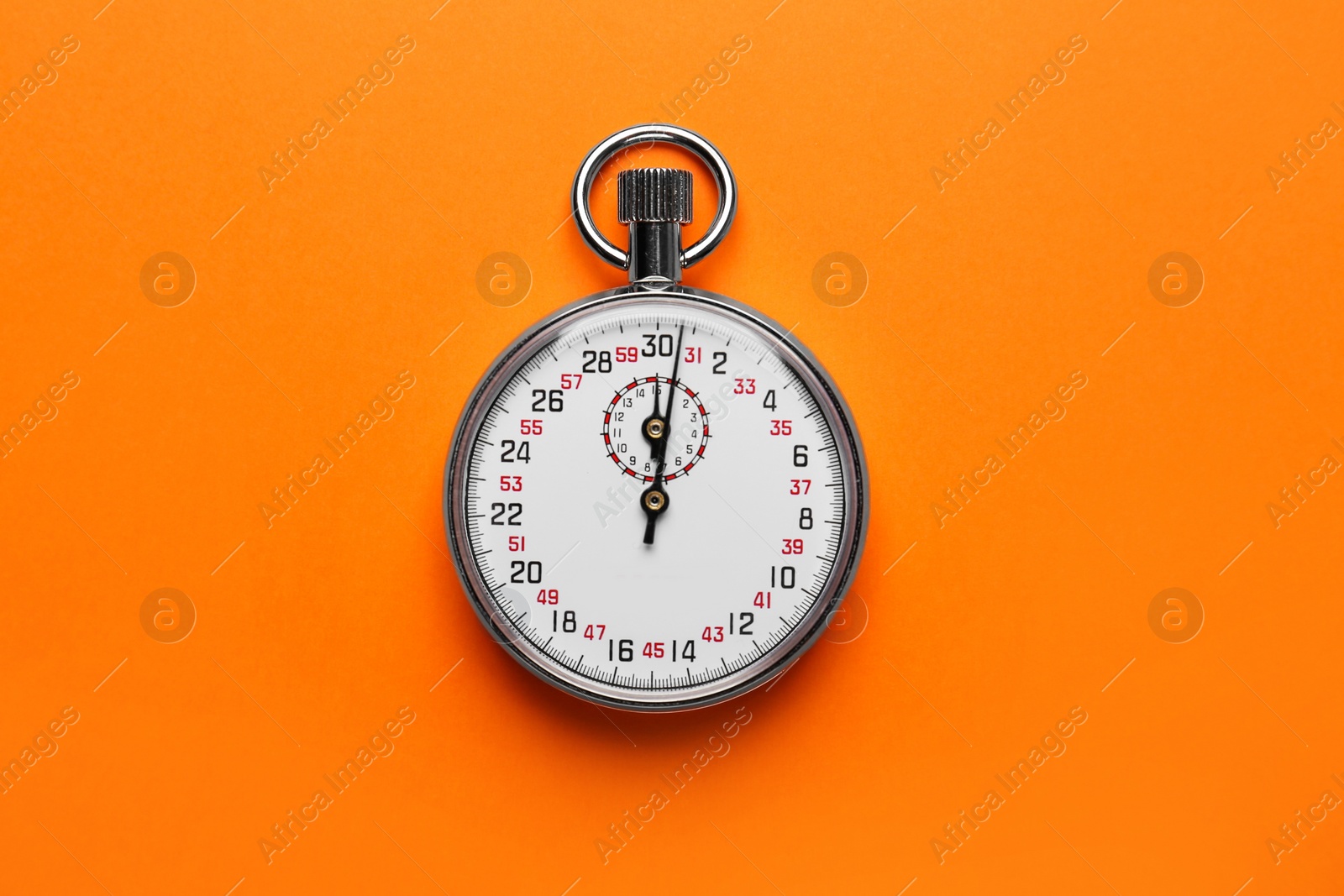Photo of Vintage timer on orange background, top view