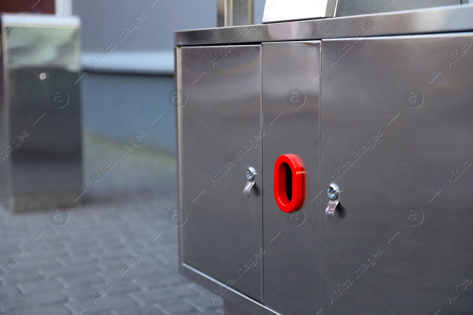 Photo of Modern metal recycling bin outdoors, closeup view. Space for text