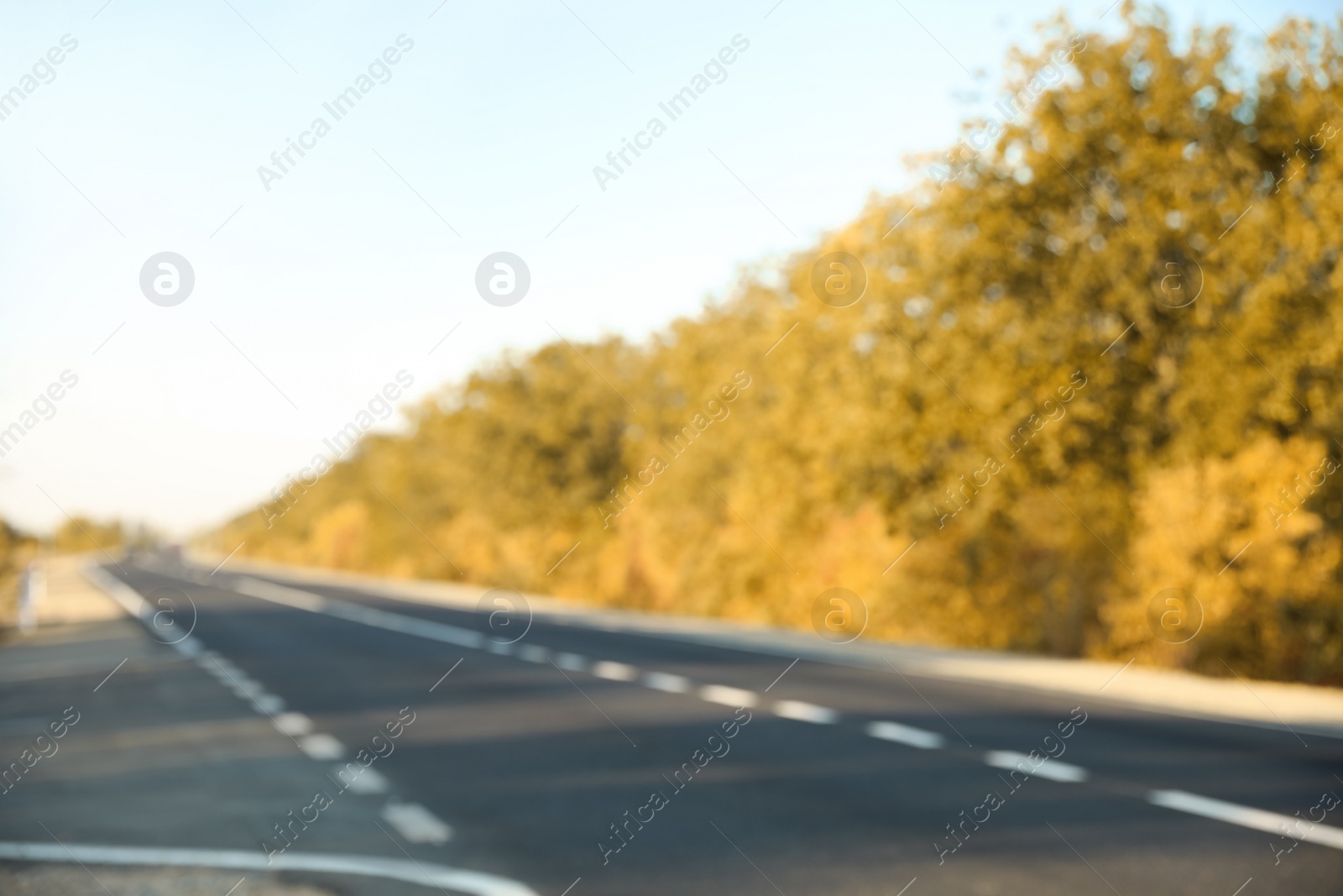 Photo of Blurred view of empty asphalt highway. Road trip