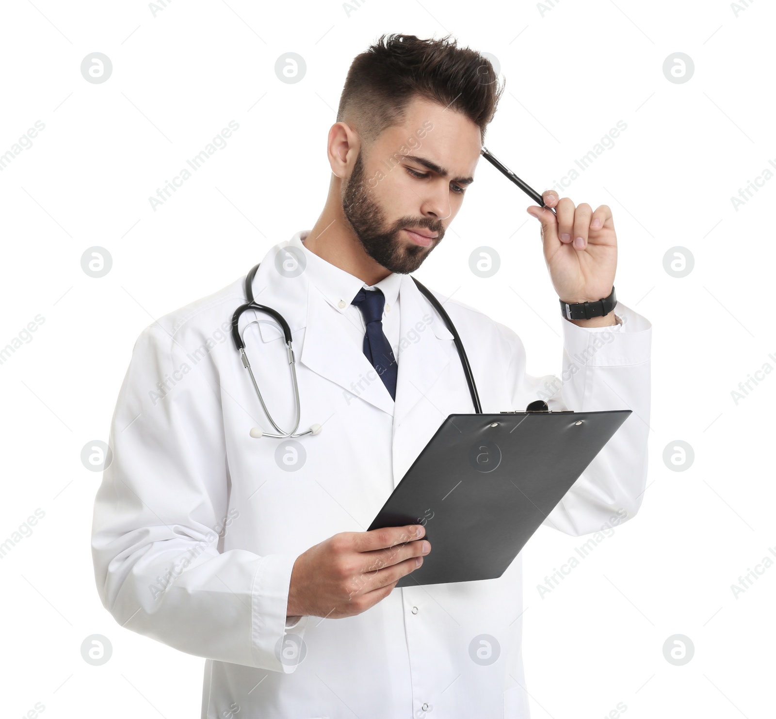 Photo of Young male doctor in uniform with clipboard isolated on white