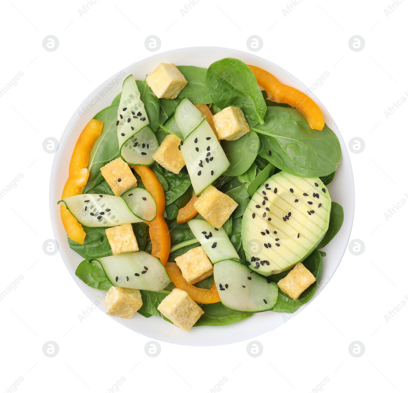 Photo of Bowl of tasty salad with tofu and vegetables isolated on white, top view