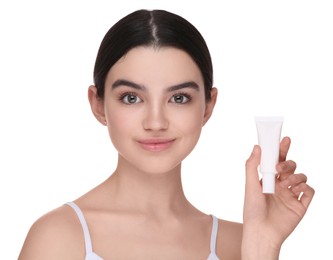 Photo of Teenage girl holding tube of foundation on white background