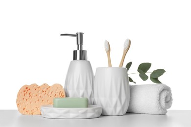 Bath accessories. Different personal care products and eucalyptus branch on table against white background