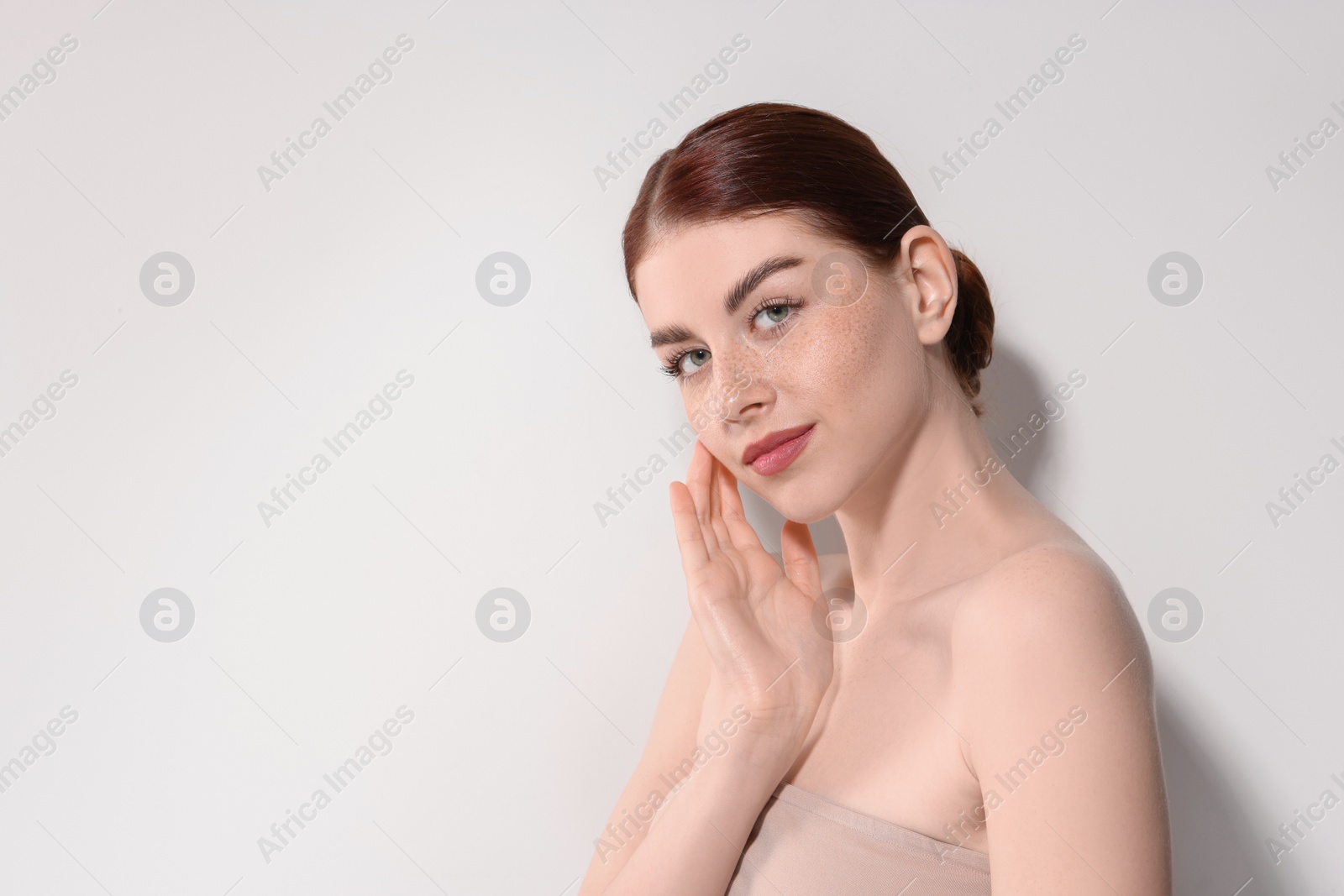 Photo of Portrait of beautiful woman on light background. Space for text