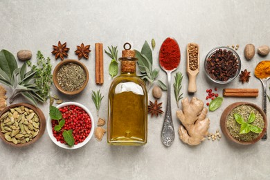 Photo of Different herbs and spices on grey table, flat lay