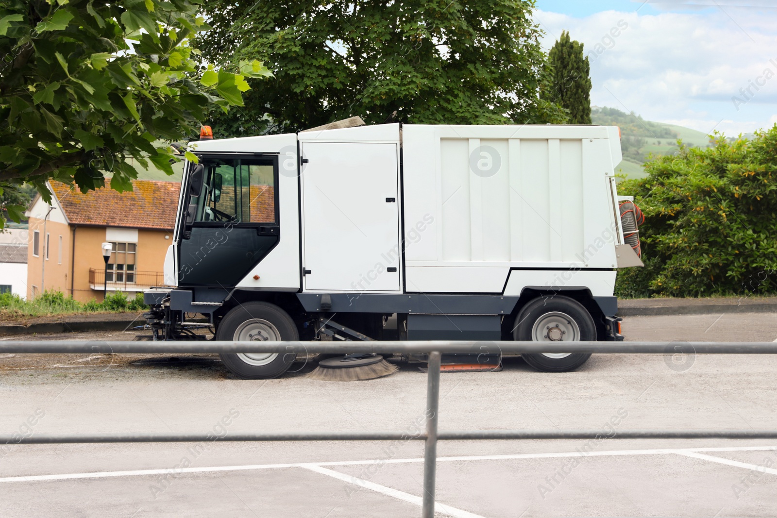 Photo of Modern sweeping car on road in city