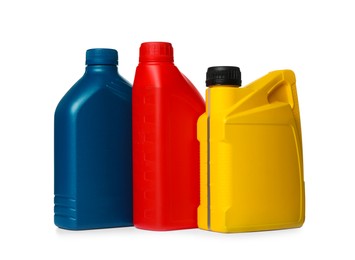 Photo of Motor oil in different containers on white background