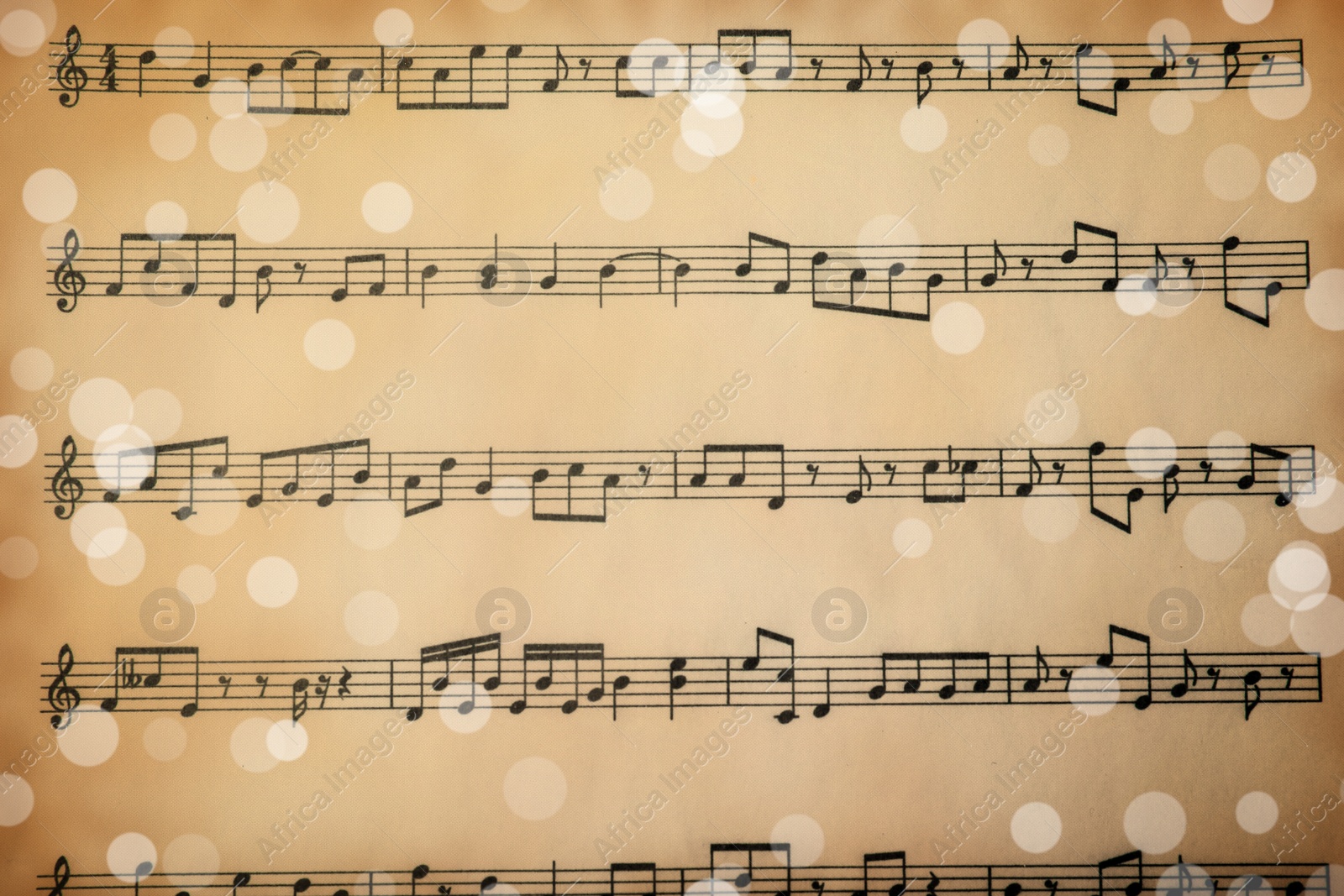 Image of Top view of old sheet with Christmas music notes as background, bokeh effect