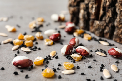 Mixed vegetable seeds on grey background, closeup