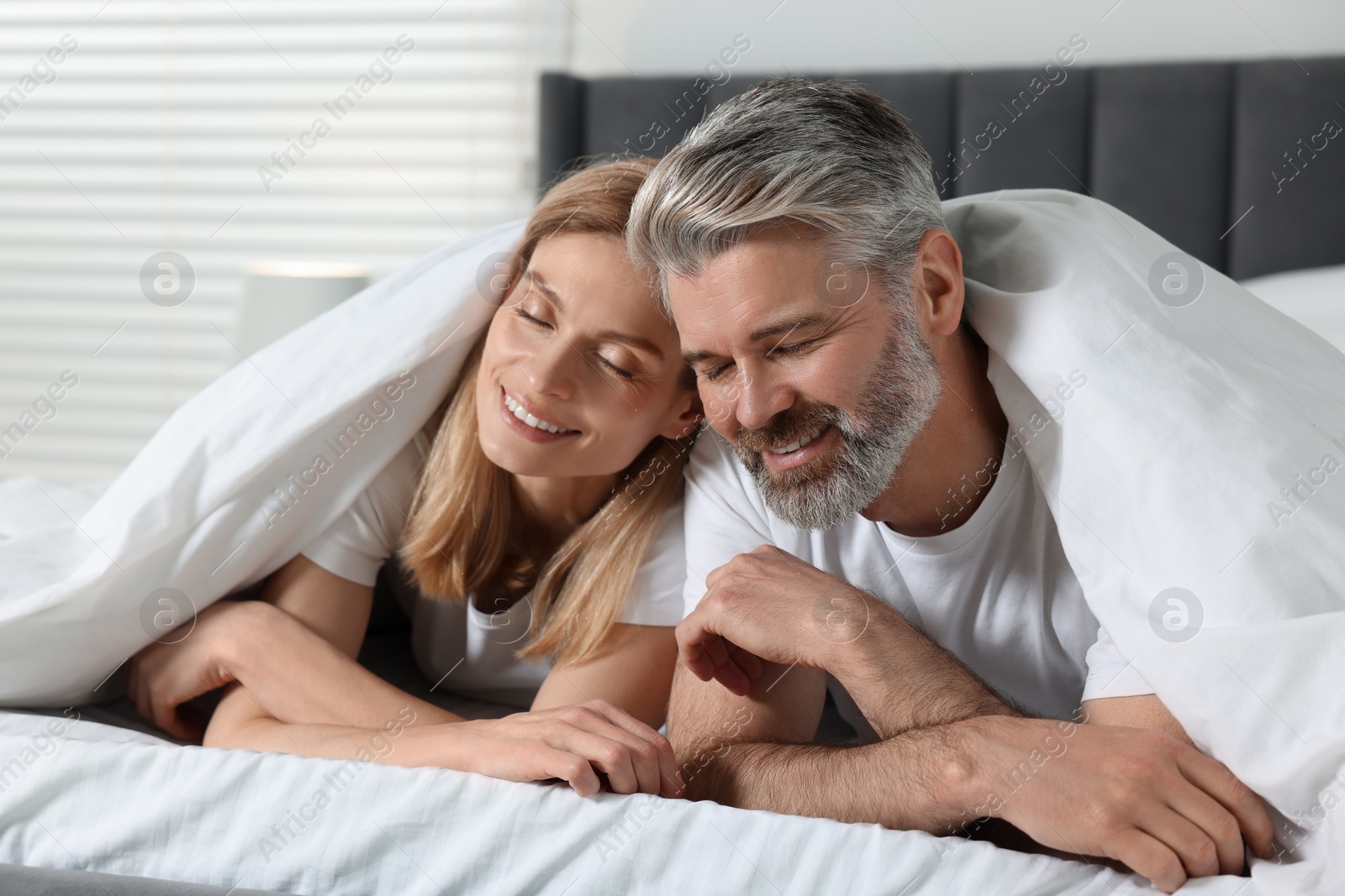 Photo of Lovely mature couple in bed at home