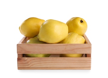 Photo of Ripe quinces in wooden crate on white background