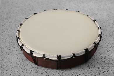 Photo of Drum on grey table, closeup. Percussion musical instrument