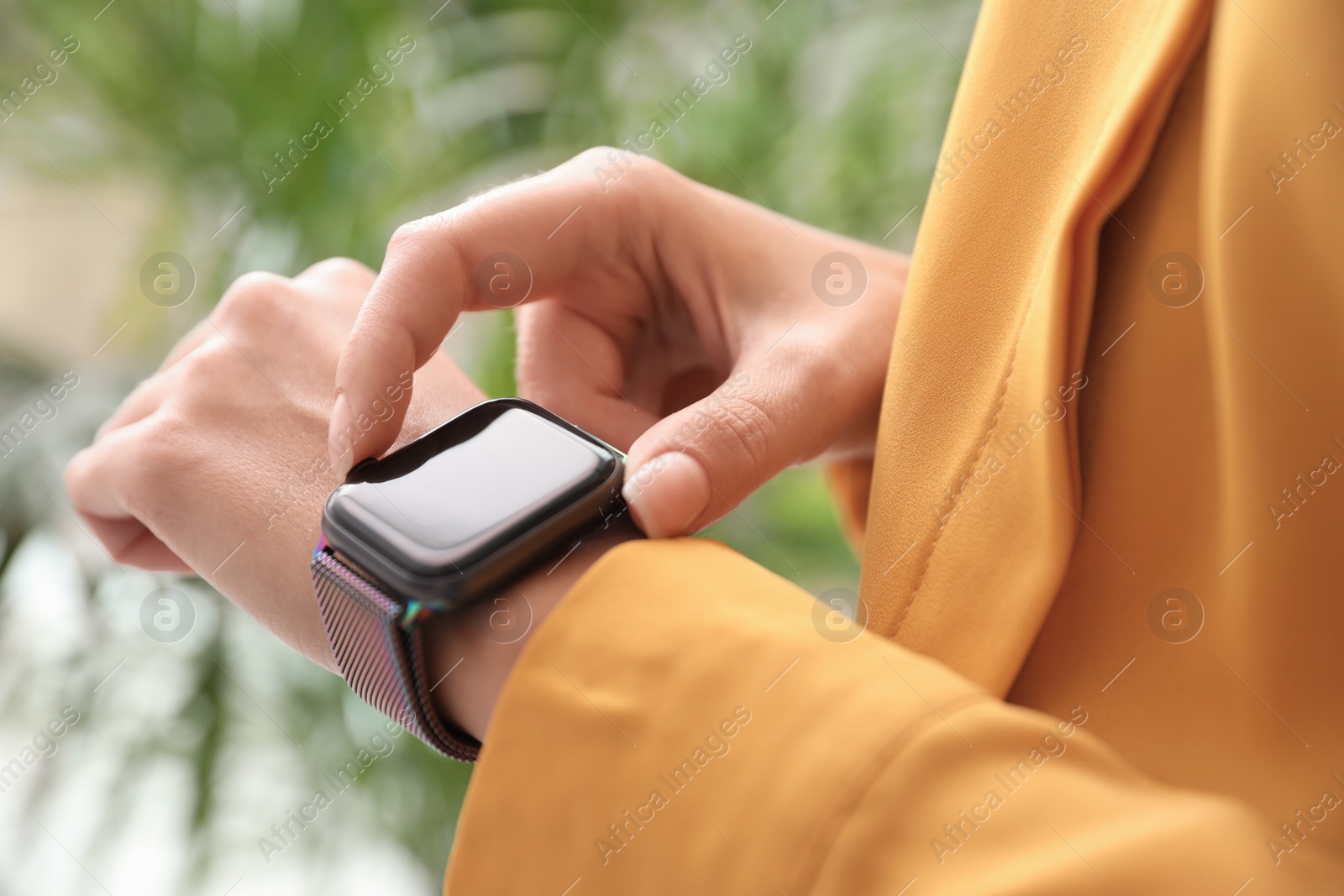 Image of Woman checking stylish smart watch at home, closeup