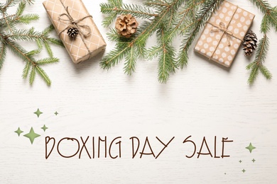 Image of Flat lay composition with gifts and text Boxing Day Sale on white wooden background
