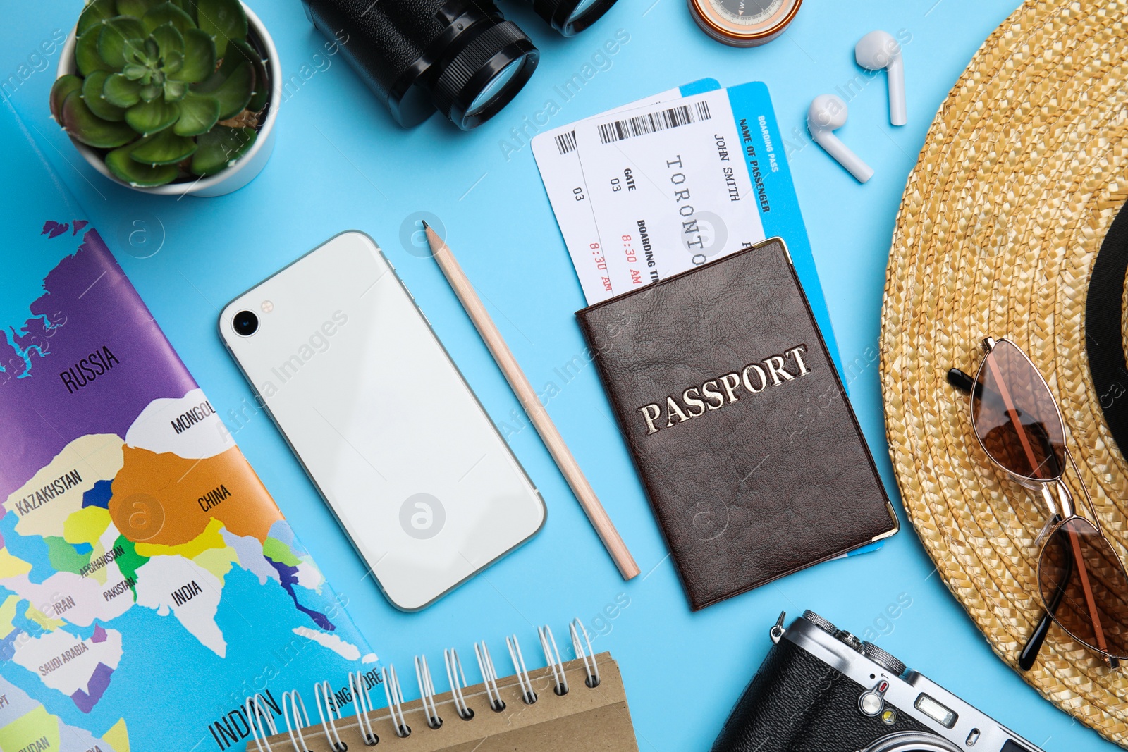 Photo of Flat lay composition with passport, tickets and travel items on light blue background