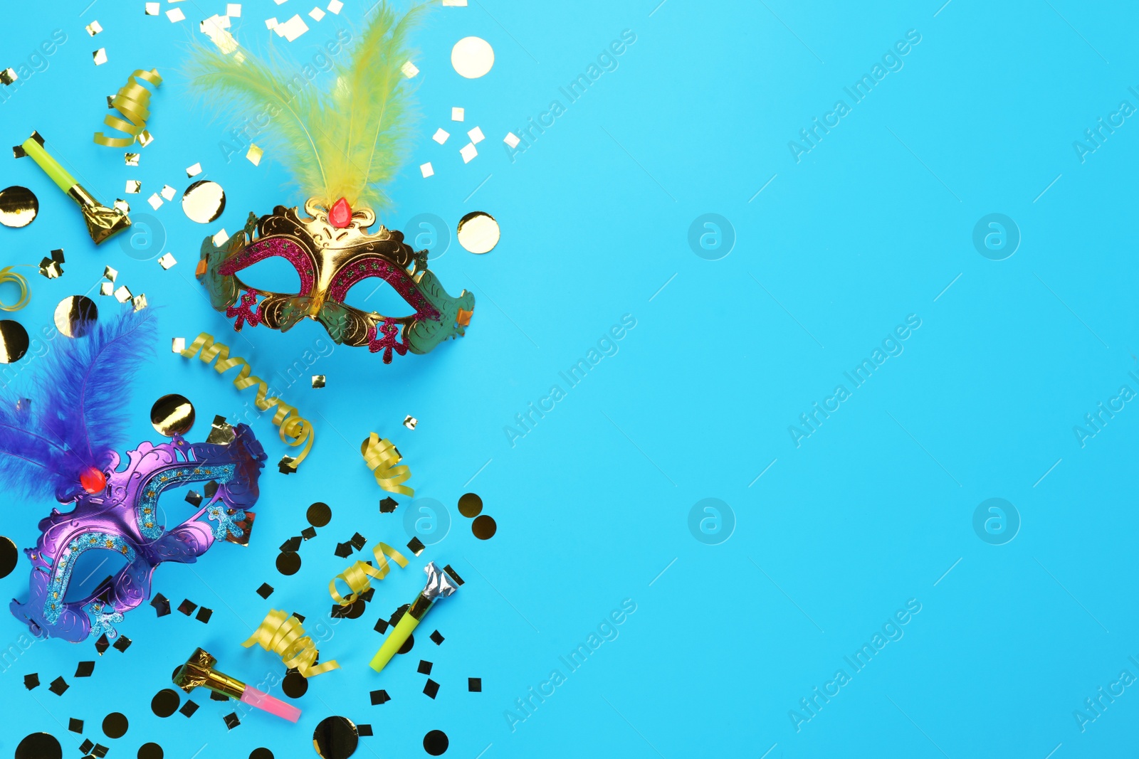 Photo of Flat lay composition with carnival items on light blue background. Space for text