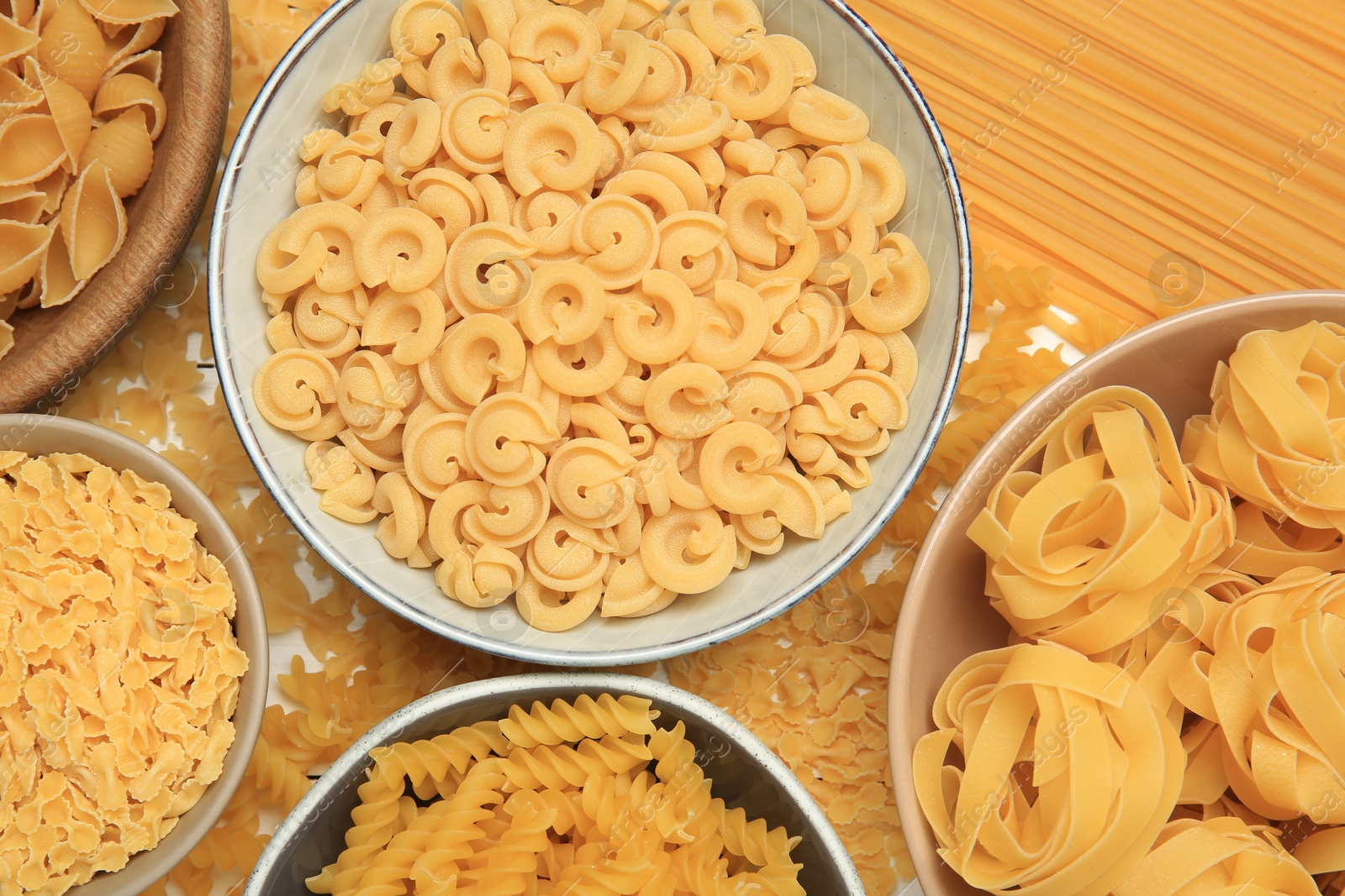 Photo of Different types of pasta on table, flat lay