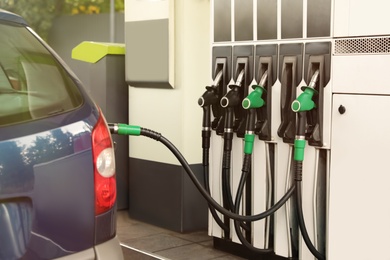 Refueling modern car at gas filling station, closeup