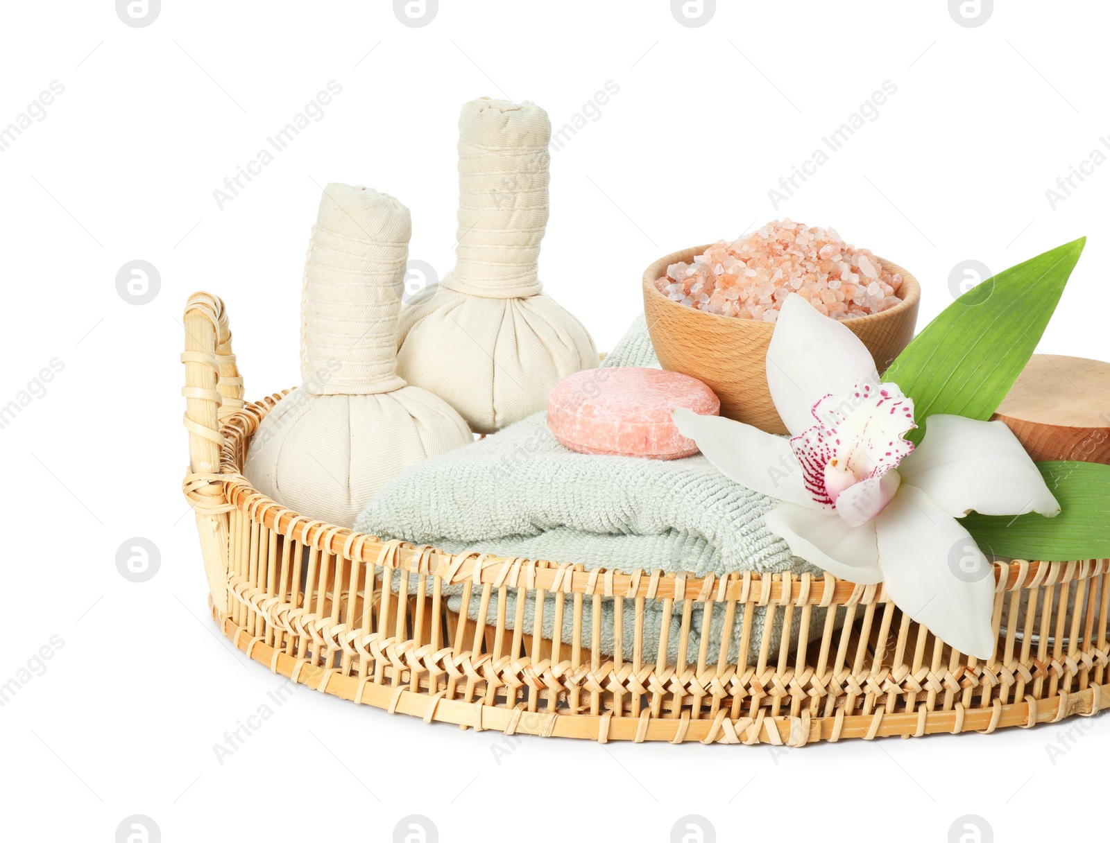 Photo of Spa composition. Towel, herbal massage bags, sea salt, soap and beautiful flower on white background