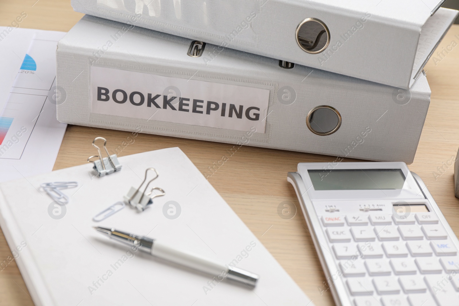 Photo of Bookkeeper's workplace with folders and documents on table