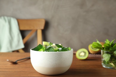 Bowl of tasty jelly on table. Space for text