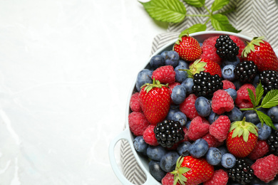 Mix of ripe berries on light table, flat lay. Space for text