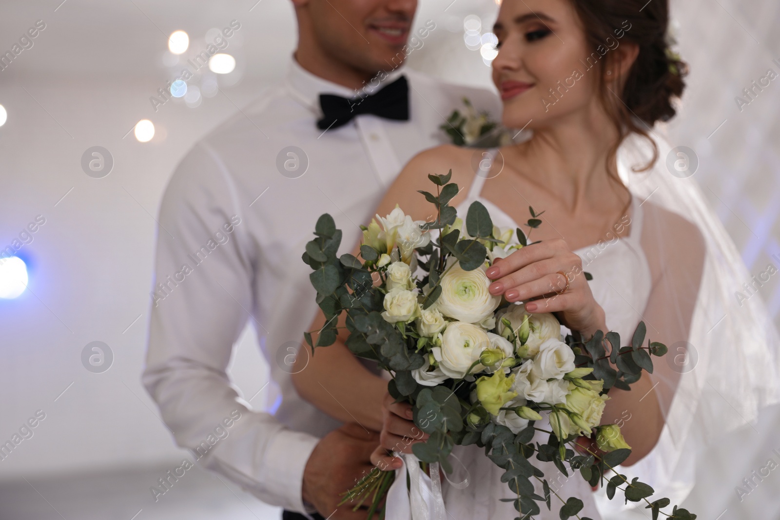 Photo of Happy newlywed couple together in festive hall, focus on hands