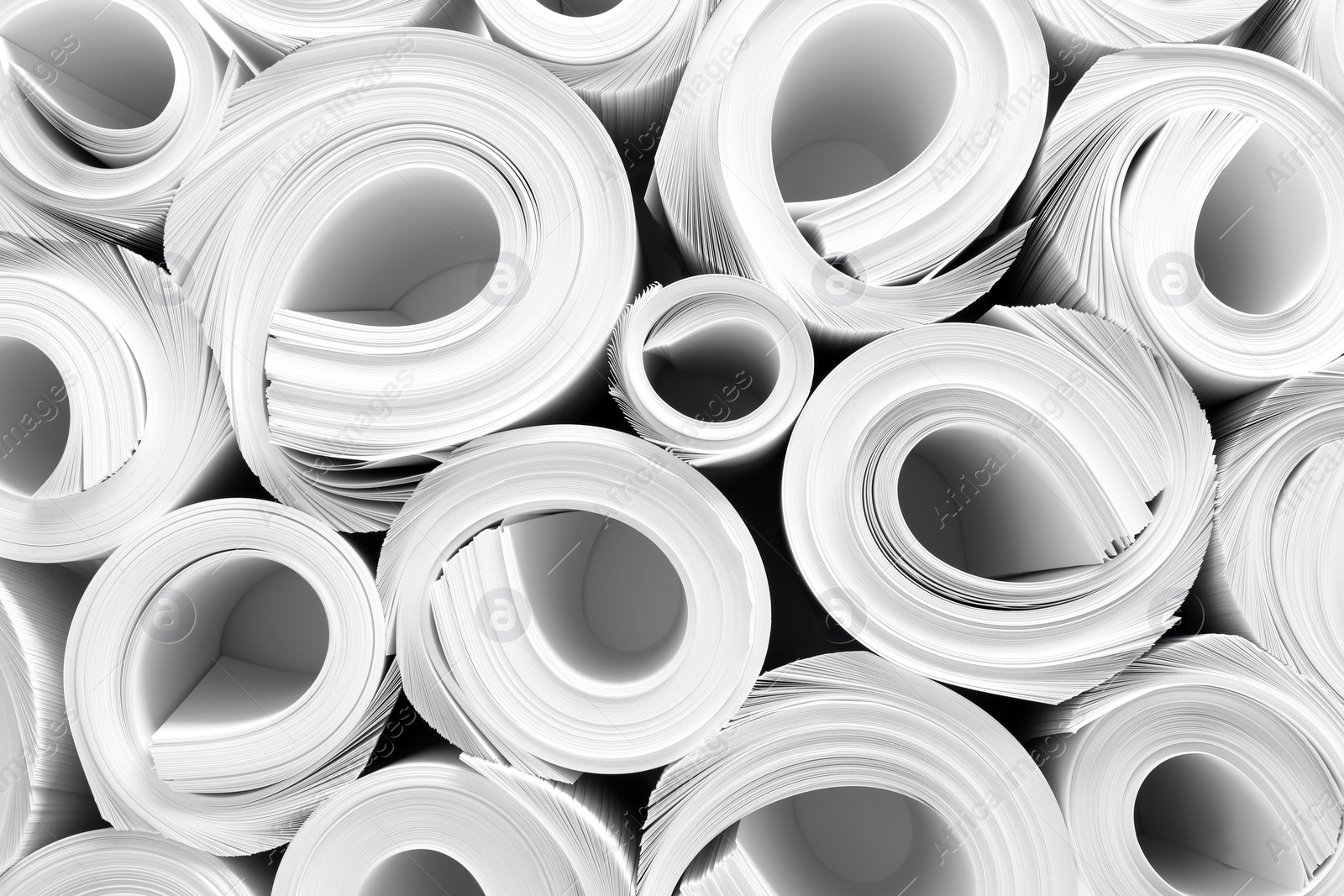 Photo of Rolled white paper sheets as background, top view