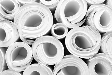 Photo of Rolled white paper sheets as background, top view