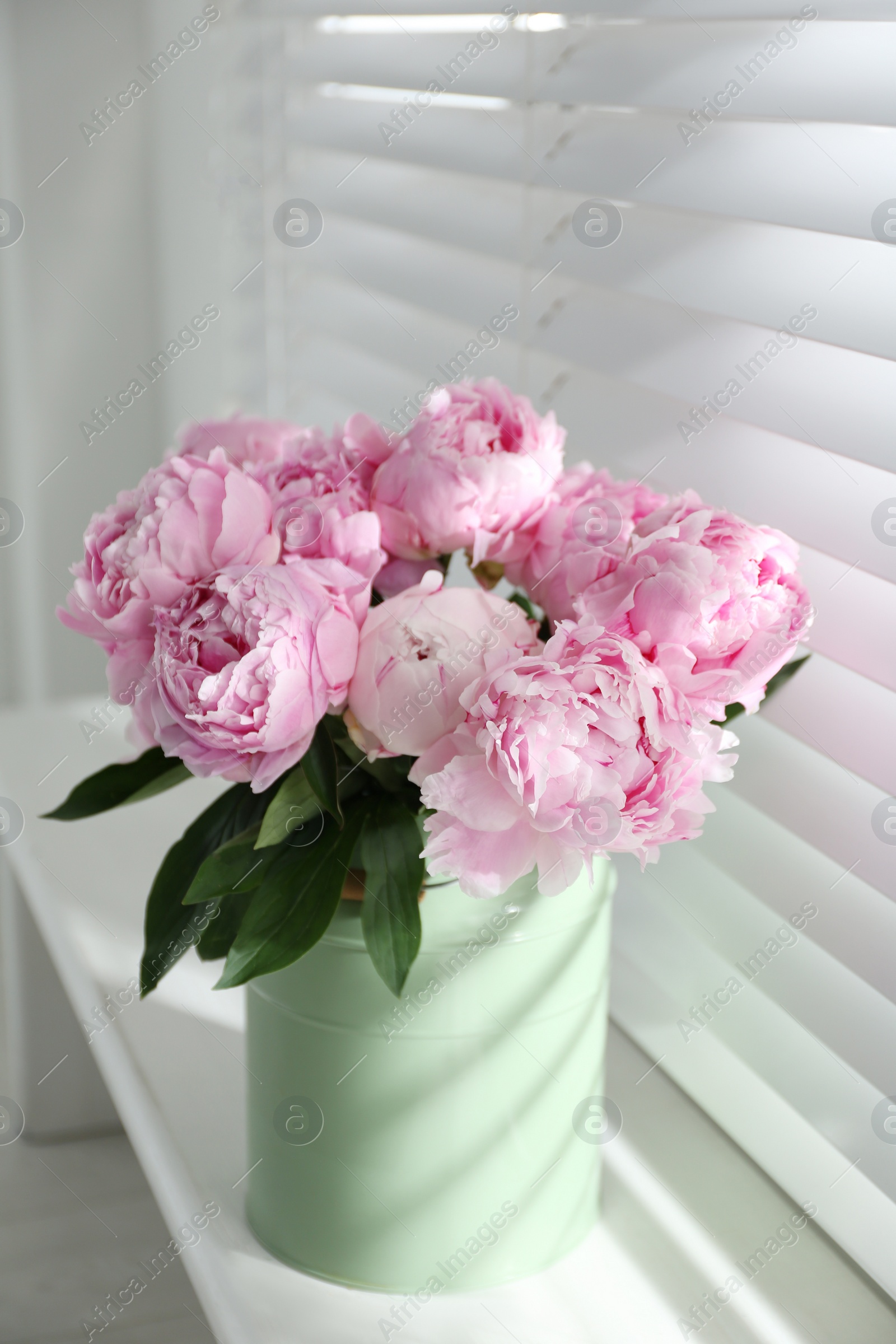 Photo of Bouquet of beautiful peonies on window sill