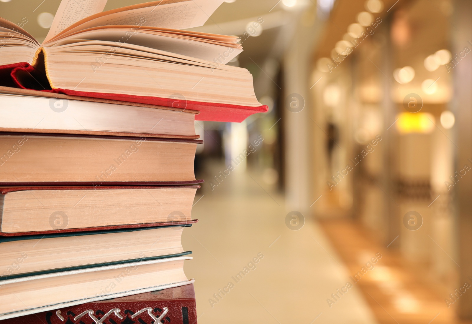Image of Collection of different books against blurred background, space for text