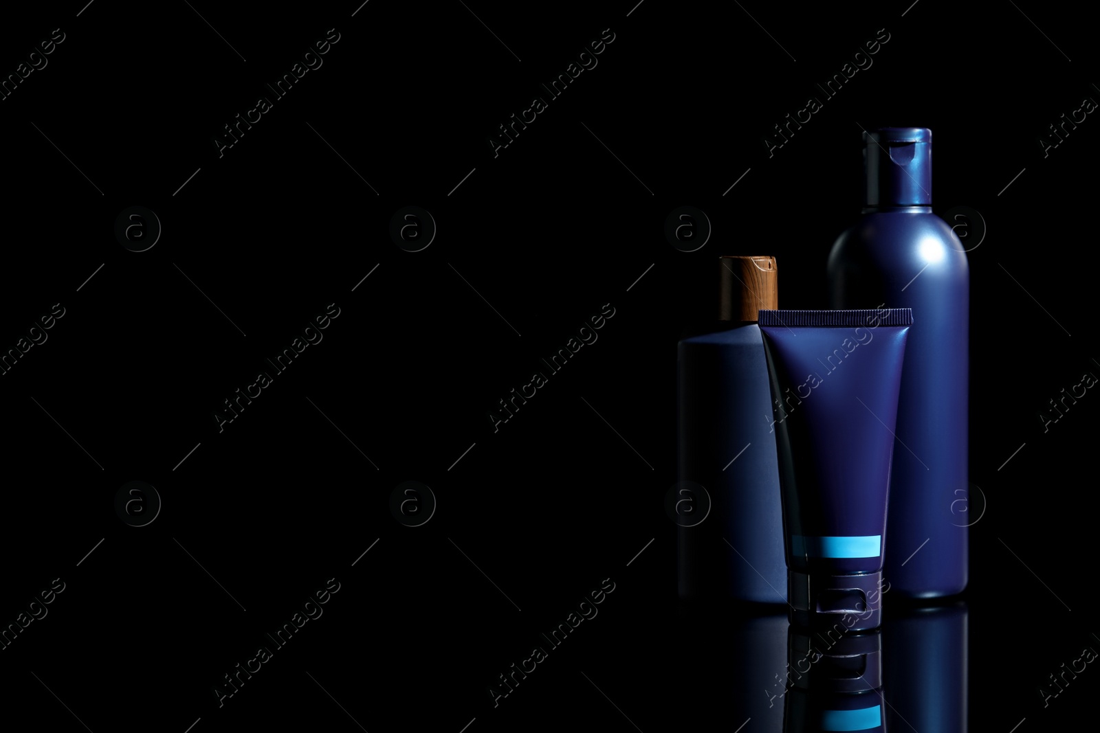 Photo of Facial cream and other men's cosmetic products on black background. Space for text