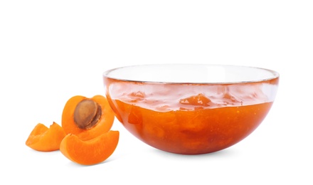 Photo of Bowl with tasty apricot jam and fruits on white background