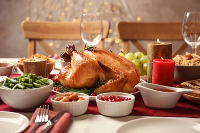 Photo of Traditional festive dinner with delicious roasted turkey served on table