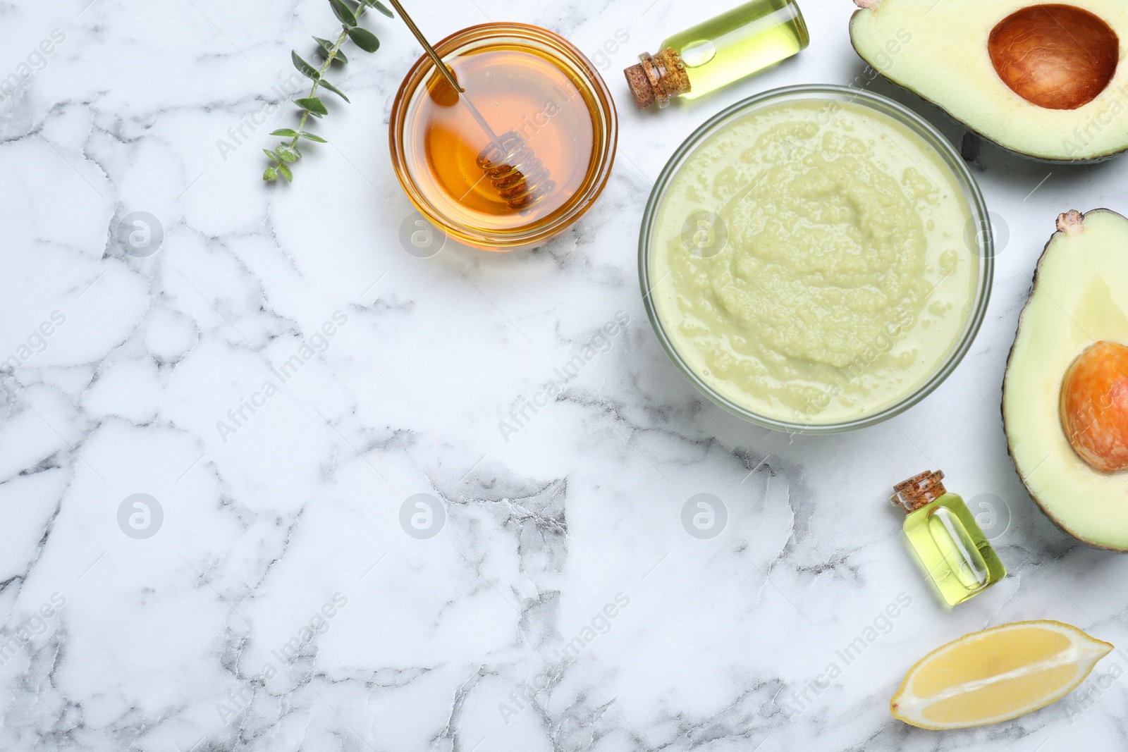 Photo of Homemade hair mask in bowl and ingredients on white marble table, flat lay. Space for text