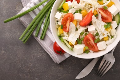 Photo of Tasty salad with Chinese cabbage served on grey table, top view. Space for text