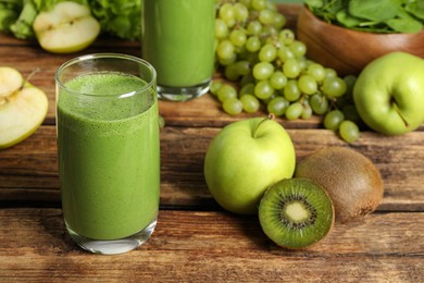 Photo of Green smoothie and fresh ingredients on wooden table
