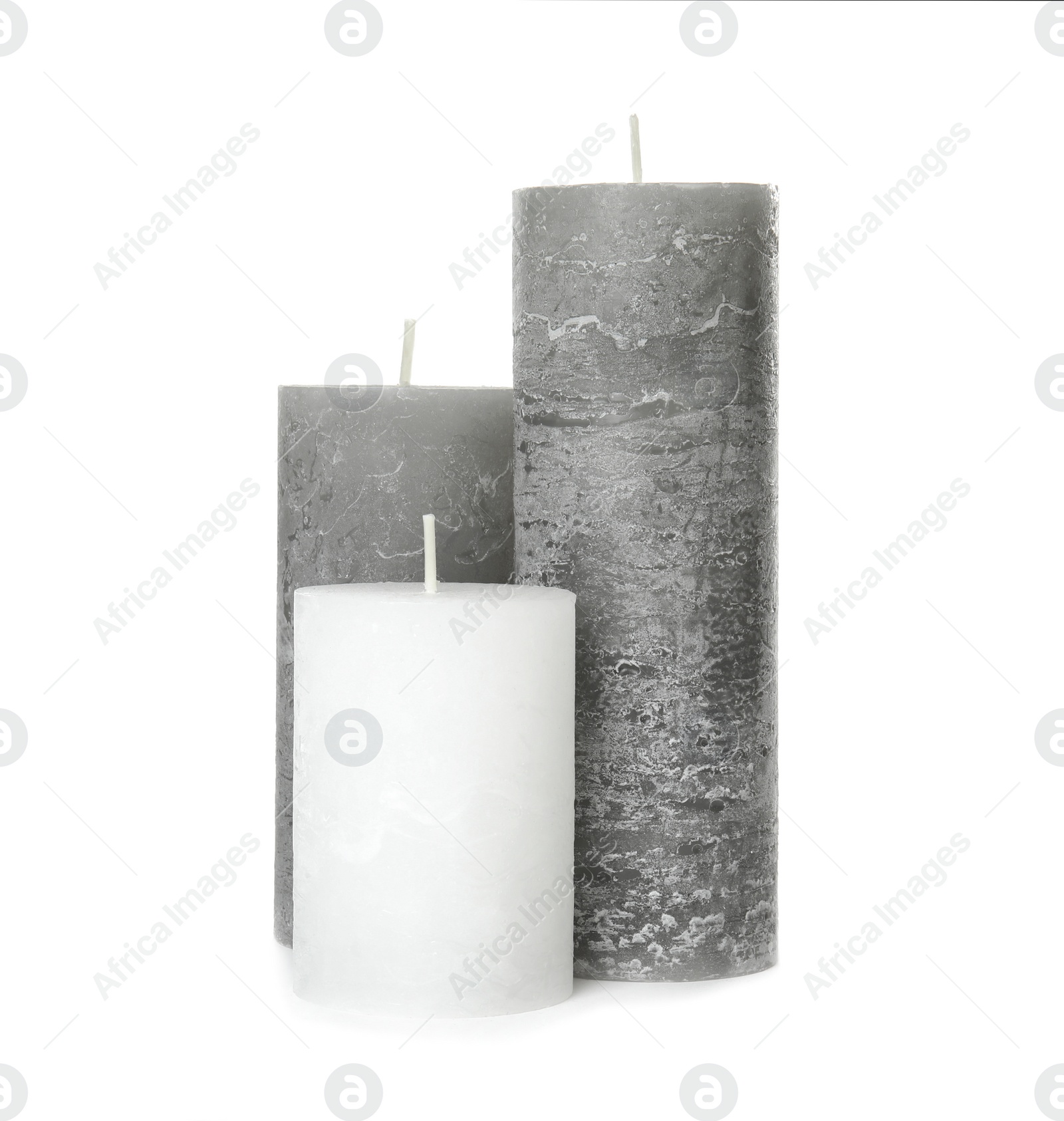 Photo of Three color wax candles on white background