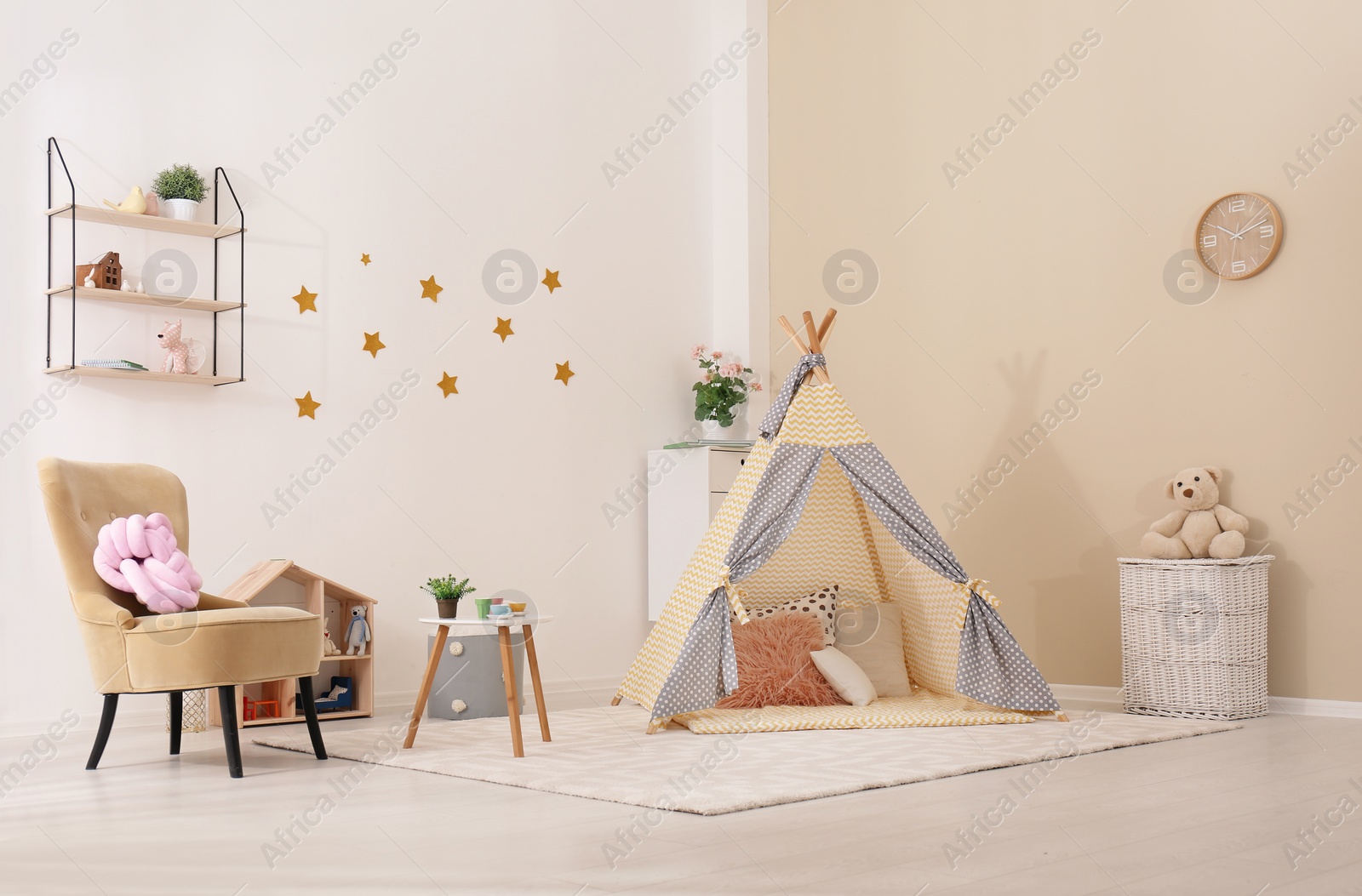 Photo of Cozy kids room interior with play tent and toys