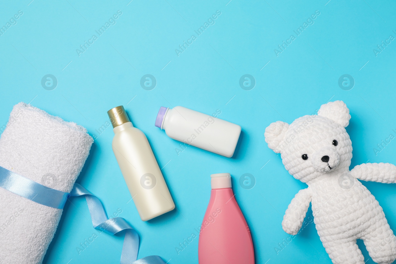 Photo of Flat lay composition with baby cosmetic products on light blue background, space for text